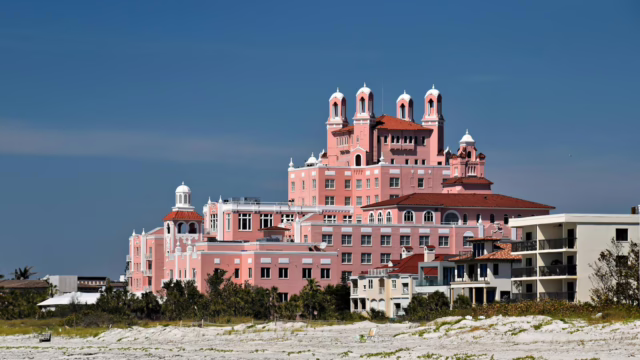 View of the iconic Don CeSar Hotel on St. Pete Beach against clear blue skies.
